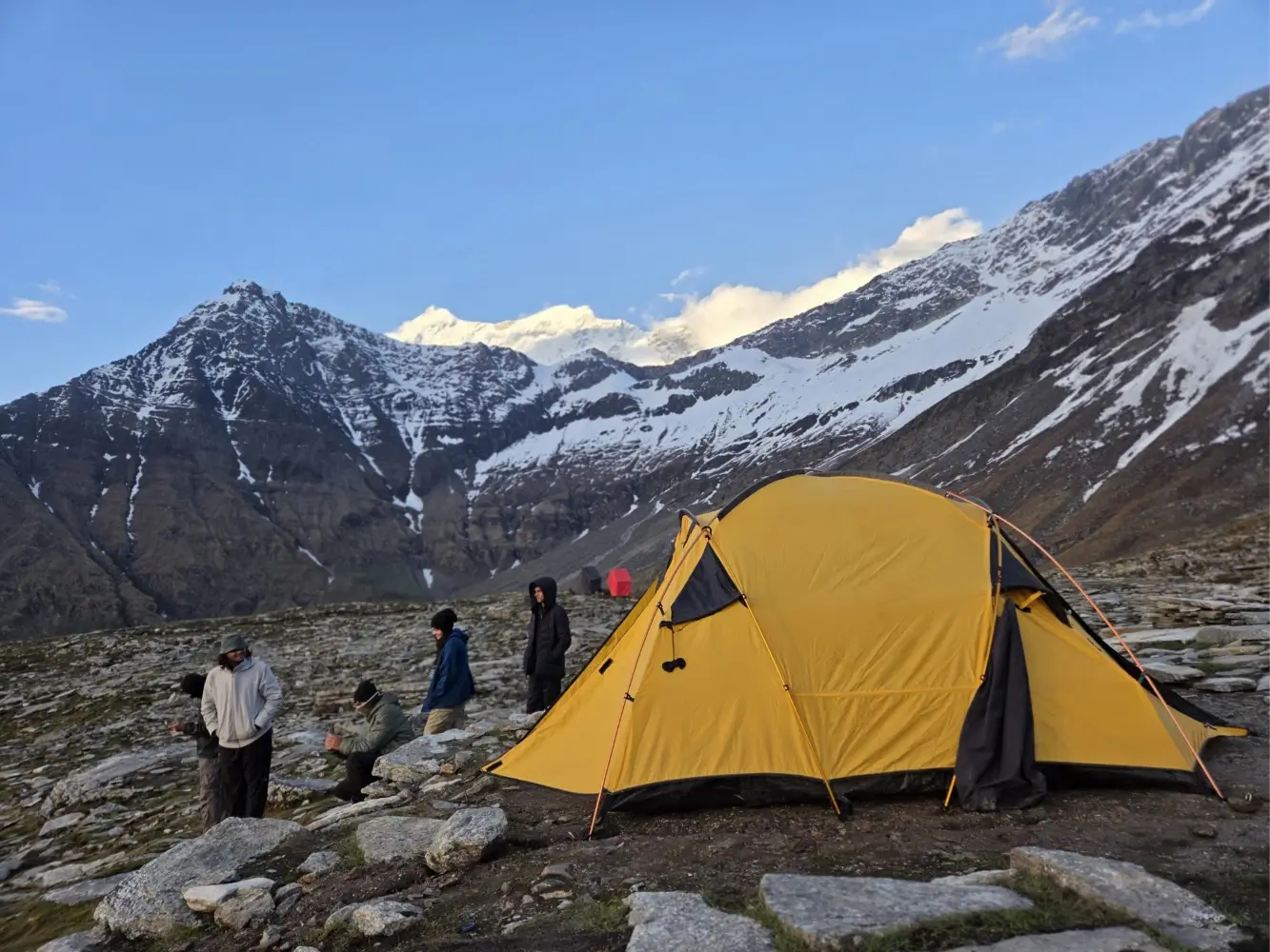 High-altitude campsite surrounded by Himalayan mountains on Roopkund Trek