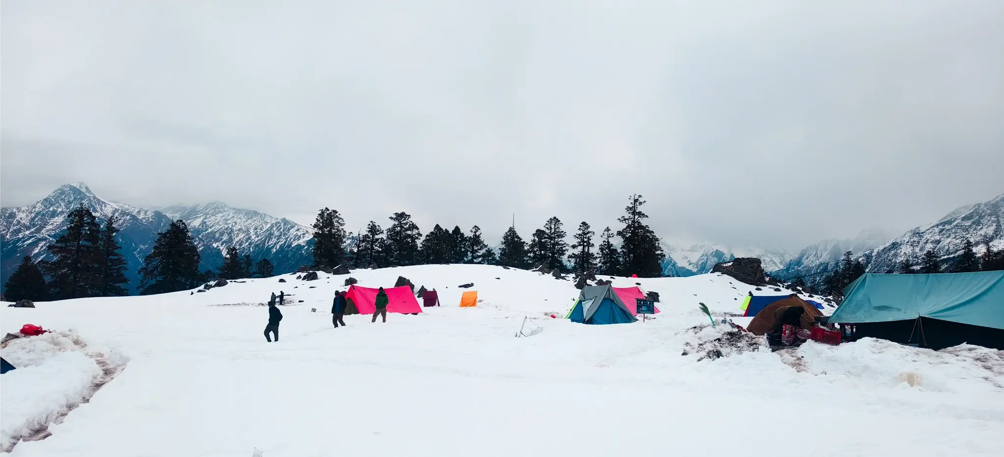 Snowy campsite with Himalayan mountains on Kuari Pass Trek